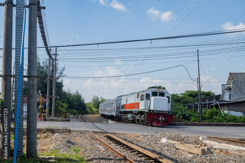 Domestic train pass the rail way when day time with blue sky.