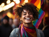 Cheerful young woman with lgbt flag smiling and taking selfie on street during pride festival on sunny summer day in city 