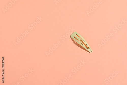Hair pin, hairstyle accessories on peach background