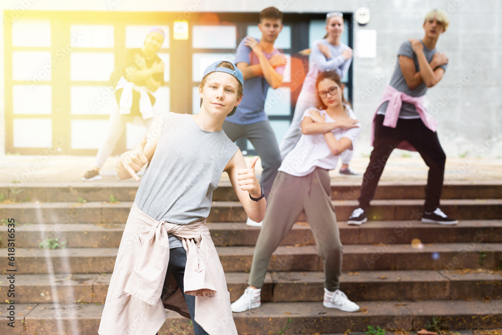 Fototapeta premium Portrait of teenager boy performing hip hop at city street