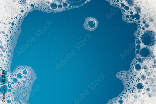 Detergent foam bubble on water. Blue background, Soap sud