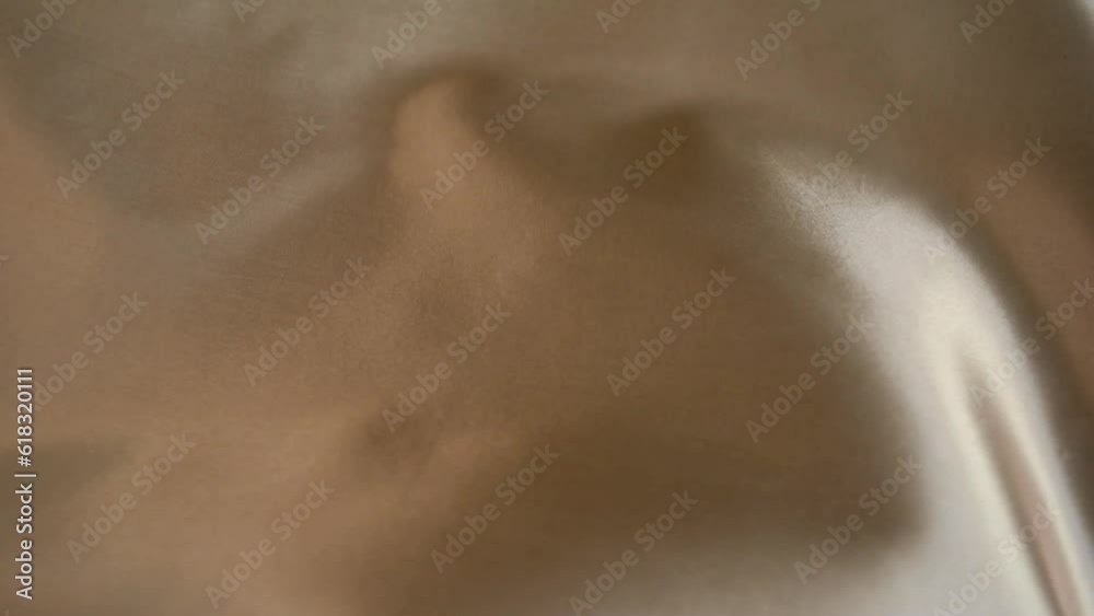 Flowing background. Movement of silk fabric. Beautiful flowing fabric, silk shimmer, shimmer and shine. The concept of softness and relaxation