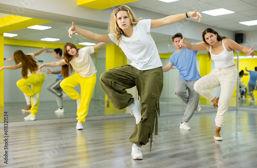 Active teenage girl practicing breakdance Footwork moves in training hall. Teenagers engaged in breakdance