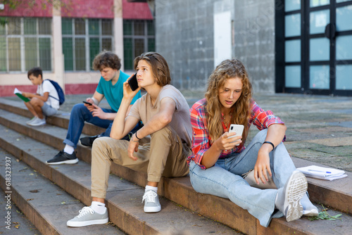 Teenagers students using smartphone on a school break