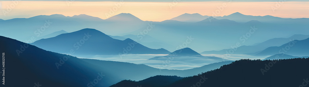 Mountain ridges covered with a forest shrouded in dawn-kissed clouds