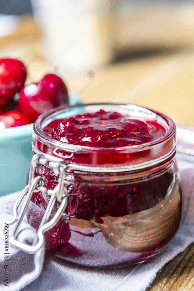An airtight glass jar filled with berry jam An airtight glass jar filled with berry jam