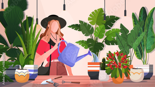 Cute funny young woman with watering can taking care of houseplants growing in pots or planters in a cozy home atmosphere. Character enjoy gardening. Modern agricultural hobby, urban farming.