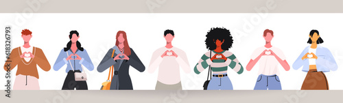 Group of young, modern people standing together and forming a heart shape with their hands. This represents team cooperation, partnership, and community. Concept of support, trust, friendship. photo