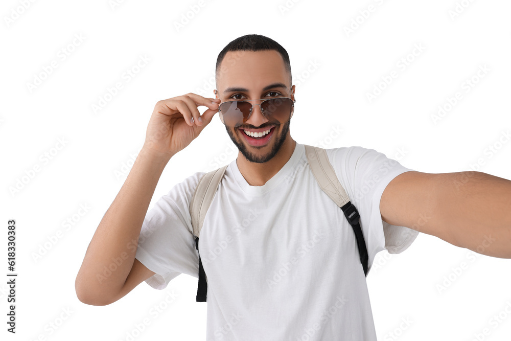 Smiling young man in sunglasses taking selfie on white background Smiling young man in sunglasses taking selfie on white background