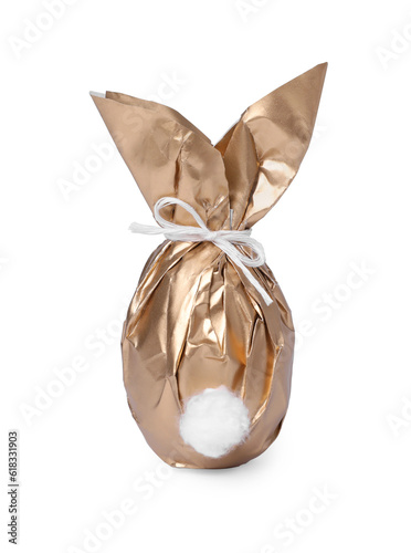 Easter bunny made of shiny gold paper and egg on white background