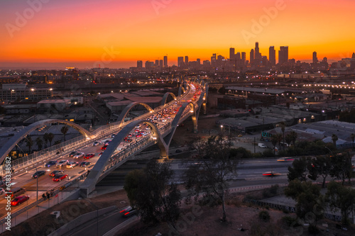 Sunset or sun rise over a bridge with Los Angeles City Skyline The Ribbon Of Light- 6th Street Bridge