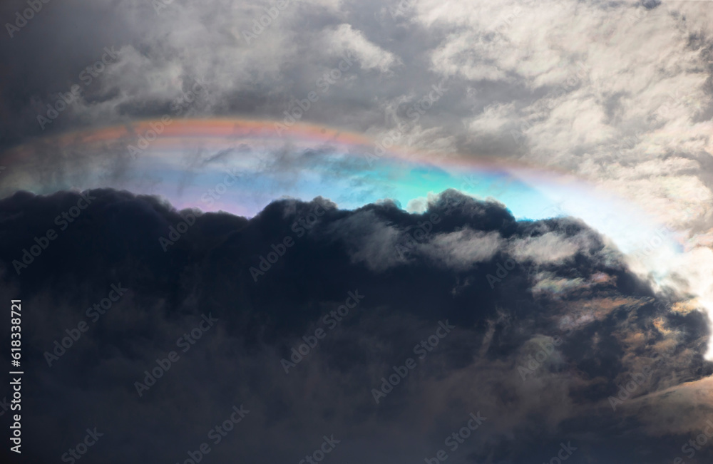 Fire Rainbow in the sky with clouds and rainclouds as background