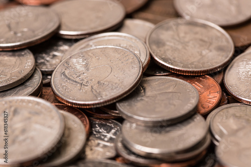 Close up of many different type of coins with jar 