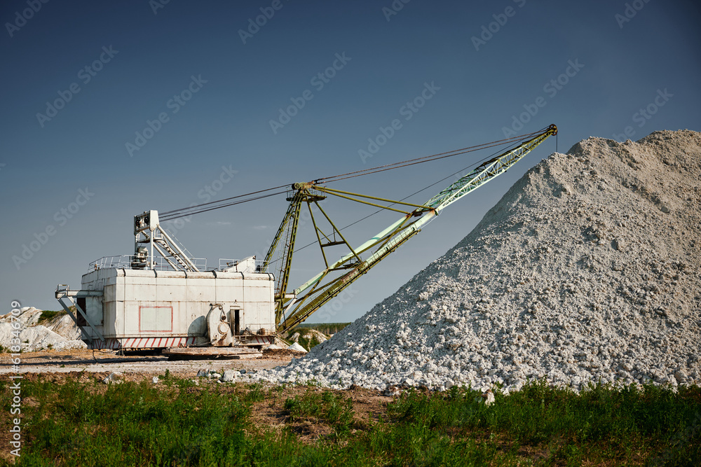 Walking excavator in process of chalk mining in open quarry