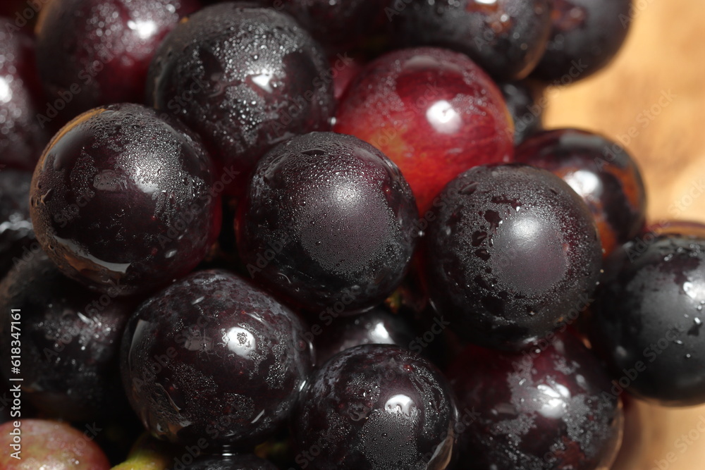 Red grapes on wooden background. Bad cholesterol prevention healthy fruits. Iron fruits Red grapes on wooden background. Bad cholesterol prevention healthy fruits. Iron fruits
