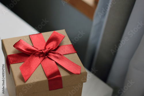 Gift box on wooden window background as a gift for Christmas, New Year, Valentine's Day or anniversary.