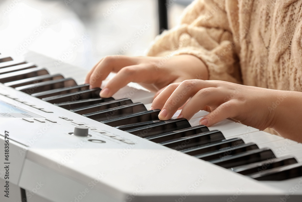 Fototapeta premium Woman playing modern synthesizer, closeup