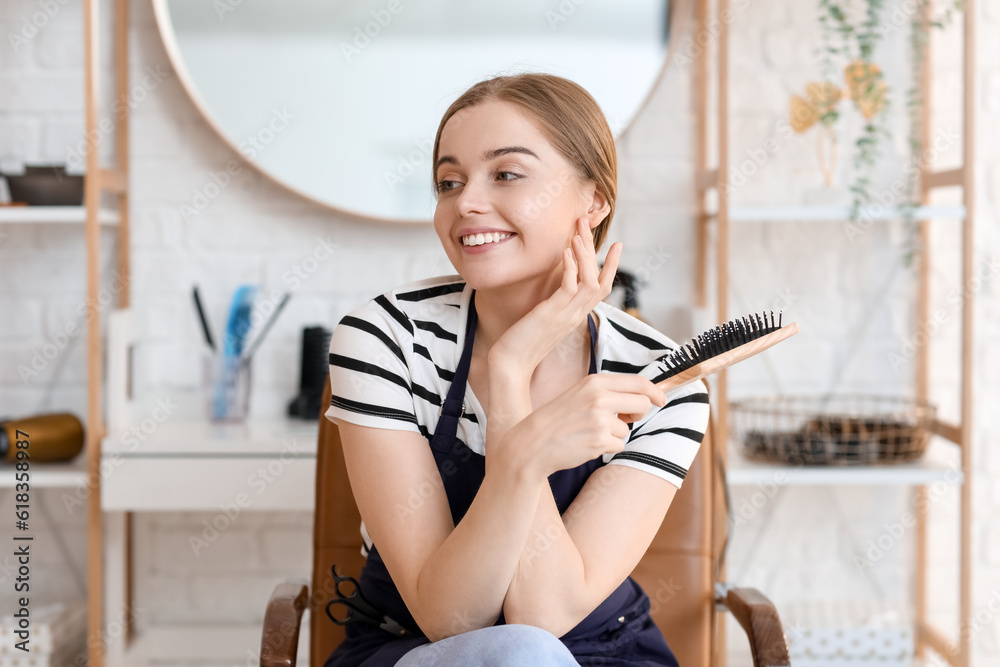 Female hairdresser with brush in beauty salon Female hairdresser with brush in beauty salon
