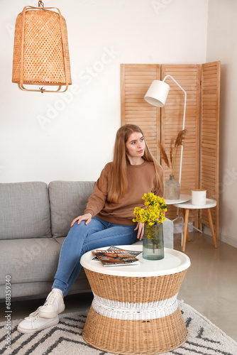 Dreaming young woman on sof...
