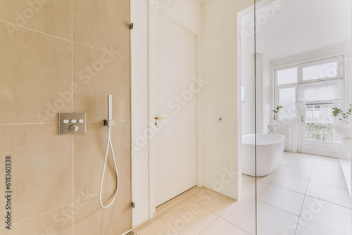 a bathroom with a shower and toilet in the corner  as seen from the inside looking into the room through the door