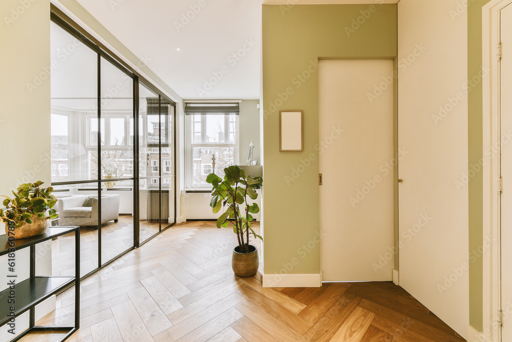 a living room with wood flooring and large glass doors that open to the balcony area in front of the house