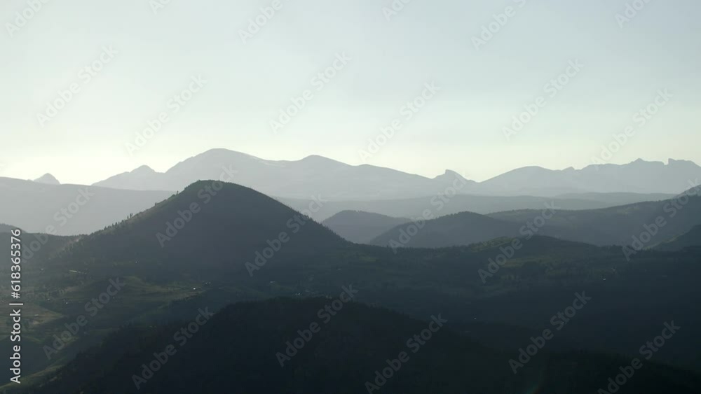 Distant dark and grey mountains covered in mist and fog, a static shot