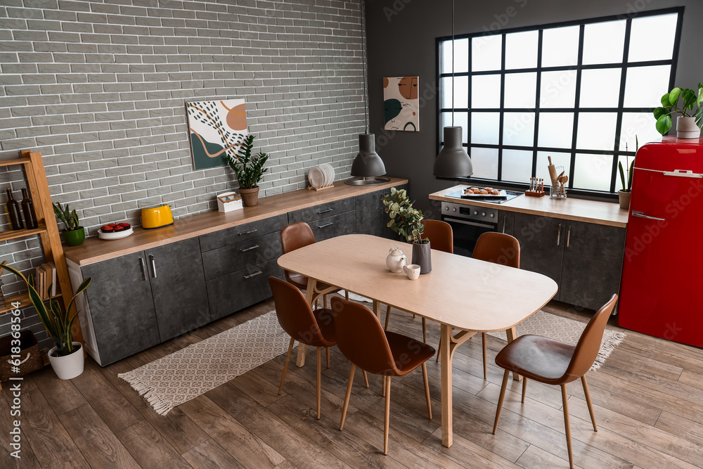 Interior of modern kitchen with dining table and grey counters Stock ...