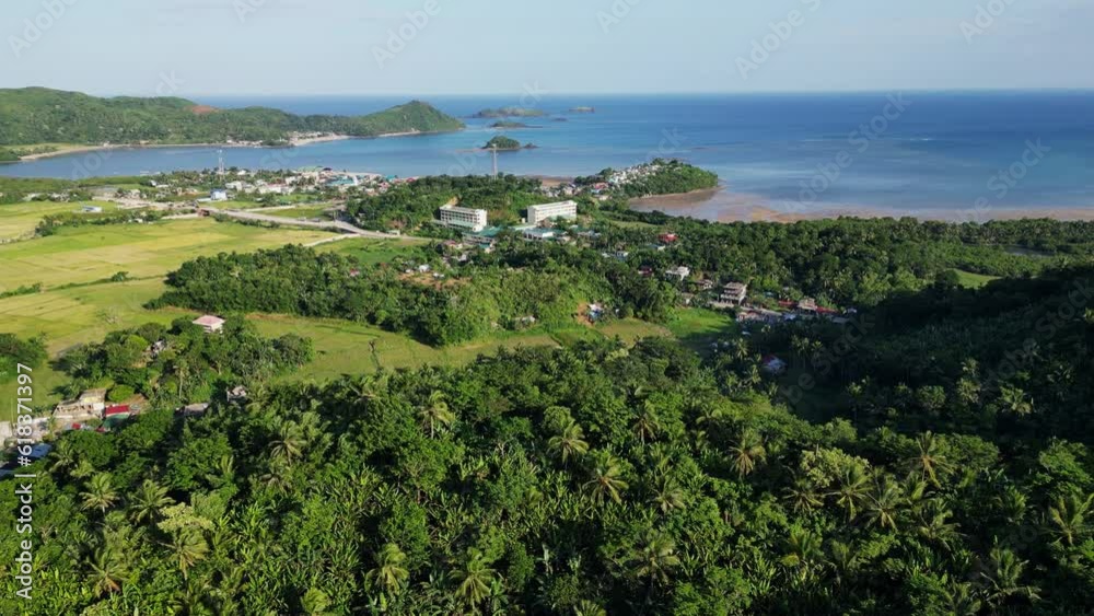 Breathtaking aerial dolly of a quaint seaside village town surrounded by calm ocean waters and lush mountains. Catanduanes, Philippines. Breathtaking aerial dolly of a quaint seaside village town surrounded by calm ocean waters and lush mountains. Catanduanes, Philippines.