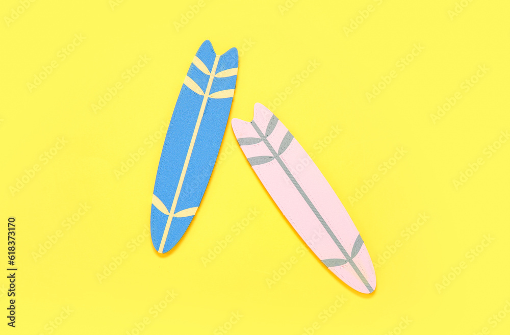 Mini colorful surfboards on yellow background Mini colorful surfboards on yellow background