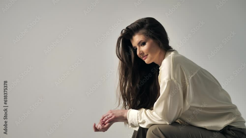 Young beautiful woman posing against a white wall in the studio. Sexy carefree young woman, fashion model