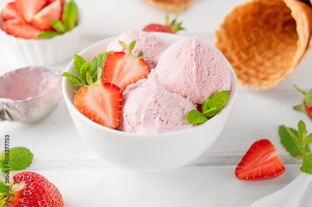Strawberry ice cream with fresh berries in a bowl on a white wooden background. Selective focus Strawberry ice cream with fresh berries in a bowl on a white wooden background. Selective focus