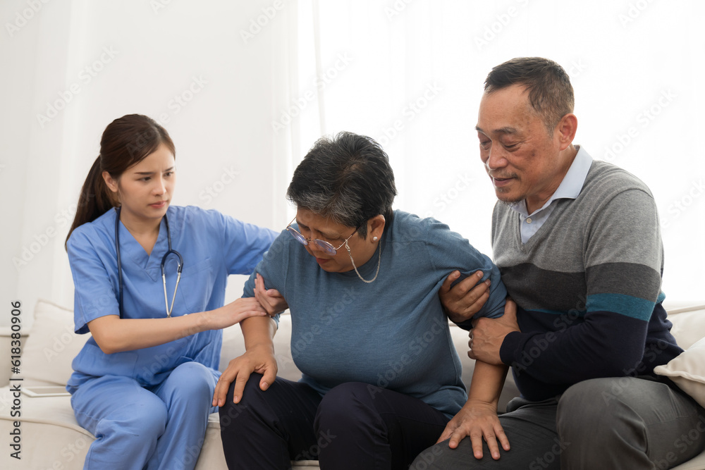 Fototapeta premium Nurse and patient Asian elderly woman. Nurse caring Asian elderly woman on sofa at hospital. Asian nurse taking care patient older woman with kindly