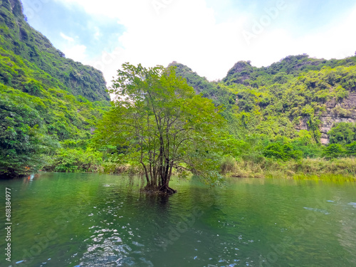 Trang An River Ninh Minh and Bai Dinh Mountain ranges in Vietnam only 3 hours drive from Hanoi. Beautiful winding river and large rising mountains. boats going through the caves in the river