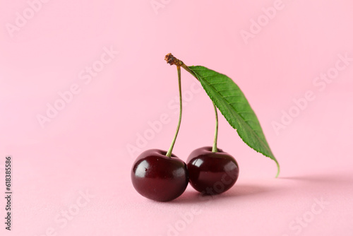 Sweet cherries with leaf on pink background