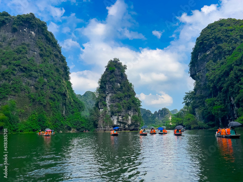 Trang An River Ninh Minh and Bai Dinh Mountain ranges in Vietnam only 3 hours drive from Hanoi. Beautiful winding river and large rising mountains. boats going through the caves in the river