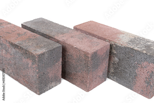 white background. brick made of concrete. multi-colored block for laying a post on the fence. close-up.