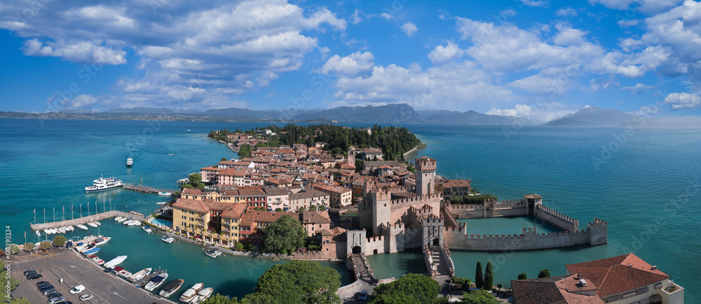 Scaliger Castle surrounded by water and sky. Sirmione on Lake Garda, Italy.
