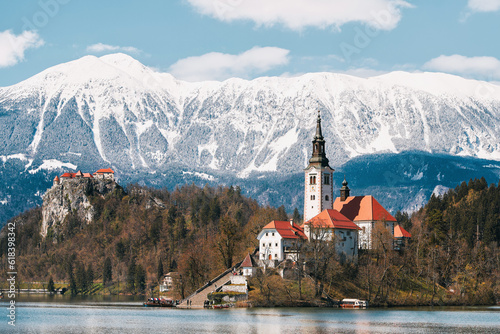 Lake Bled with Saint Mary Church of Assumption on small island. Bled, Slovenia, Europe. Mountains and valley on background. Staircase, stairs lead to church.