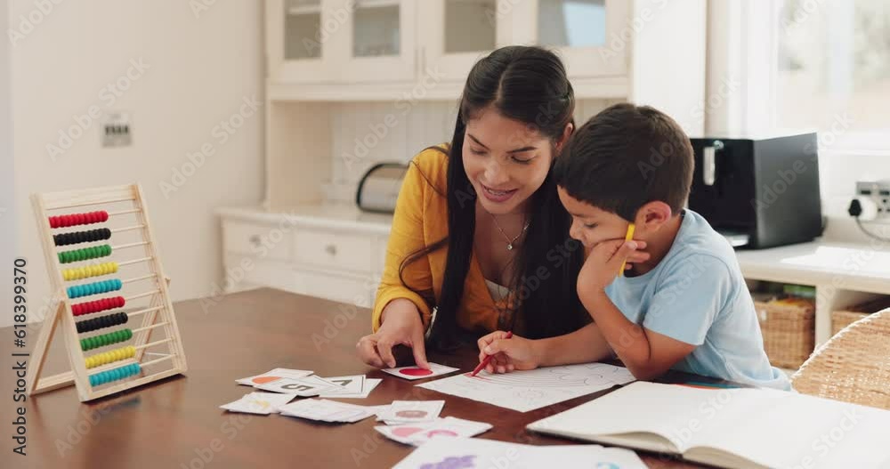 Mother helping her child with homework at their home in the dining room with math flash cards. Learning, education and young woman teaching her boy kid counting with abacus for school in their house. Mother helping her child with homework at their home in the dining room with math flash cards. Learning, education and young woman teaching her boy kid counting with abacus for school in their house.