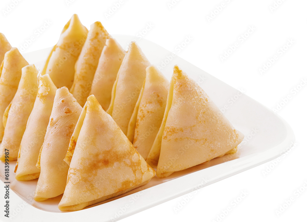 triangular pancakes with meat on plate