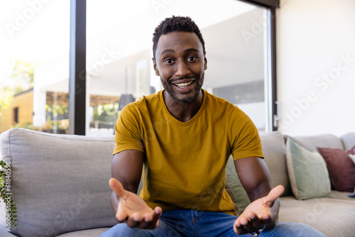 Happy african american man making video call in living room