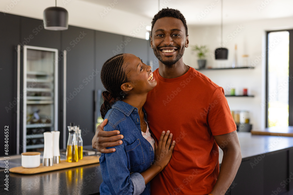 Portrait of happy african american couple embracing in kitchen Portrait of happy african american couple embracing in kitchen