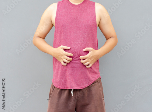 Wallpaper Mural Asian man scratching itch with hand on belly area, health care concept Torontodigital.ca