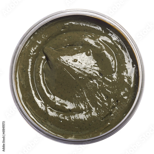 Natural cosmetic face and hair mask from french green clay with dried plants and herbs, rich smooth texture isolated on white background. Skin clay healing mud with essential oils, close up. photo