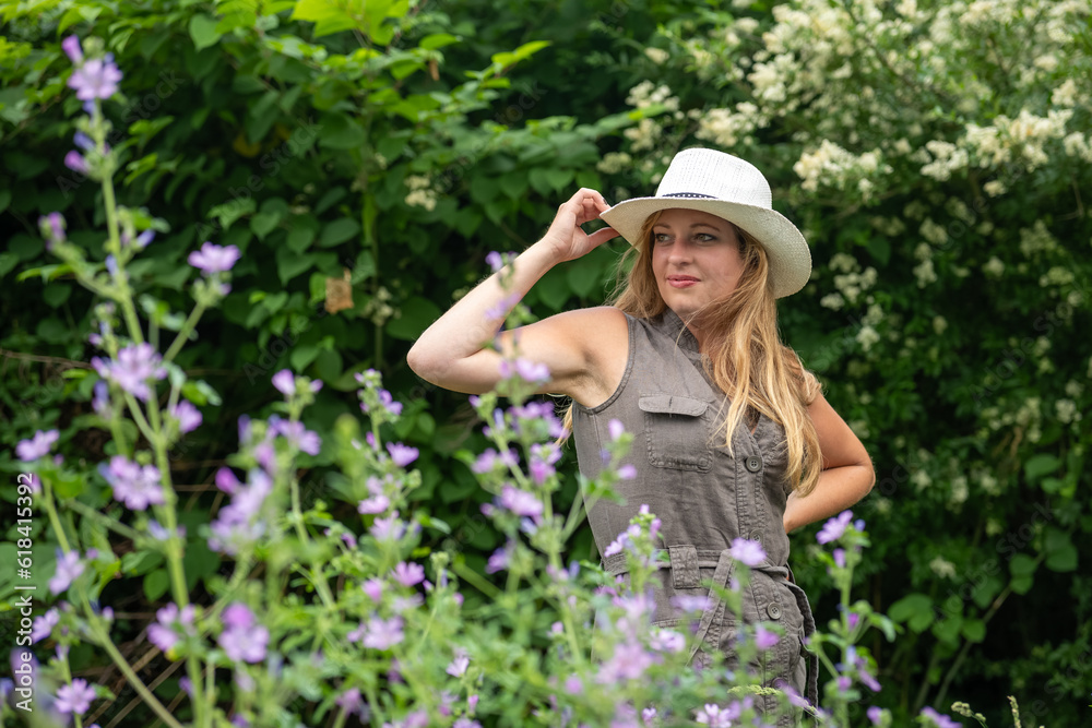 pretty blonde woman with hat and beautiful pose in nature