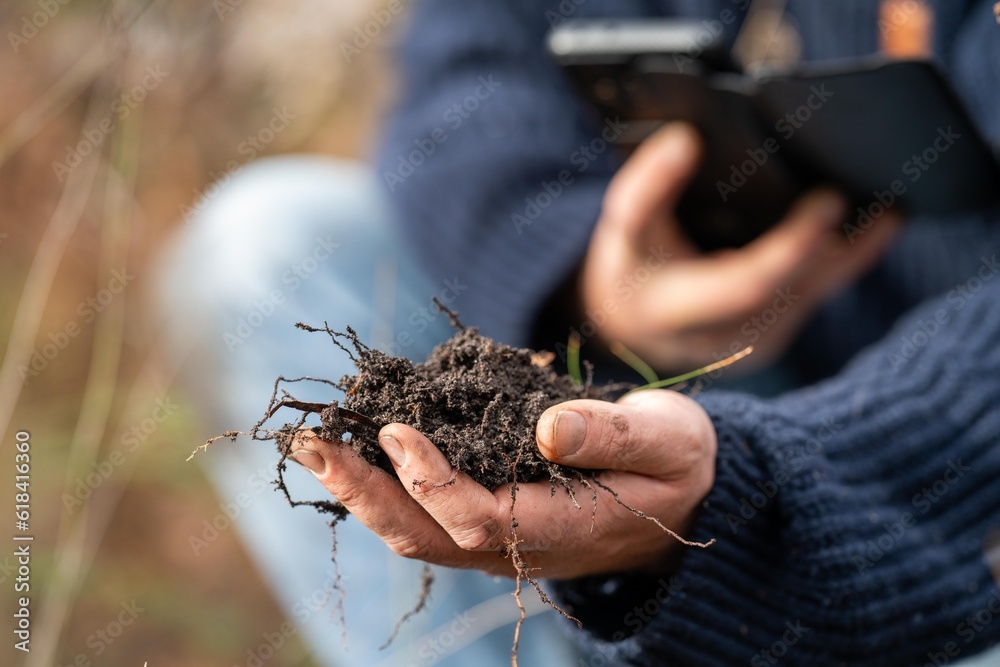 regenerative organic farmer, taking soil samples and looking at plant growth in a farm. practicing sustainable agriculture. regenerative organic farmer, taking soil samples and looking at plant growth in a farm. practicing sustainable agriculture.