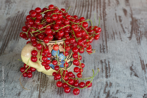 ripe red currant in a cup on the table