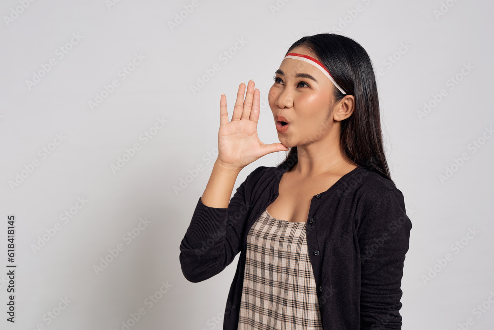 Excited Young Asian woman looking side and scream hot news about sales discounts with hands near mouth isolated over white background. Indonesia independence day 17 august Excited Young Asian woman looking side and scream hot news about sales discounts with hands near mouth isolated over white background. Indonesia independence day 17 august