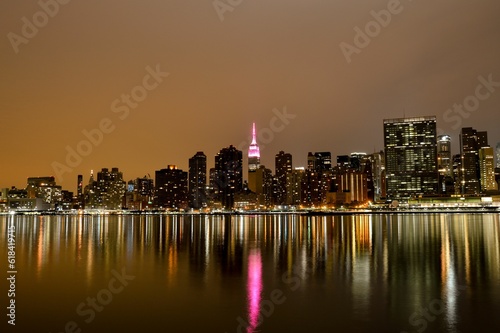 Stunning nighttime view of New York cityscape at night with buildings illuminated by lights