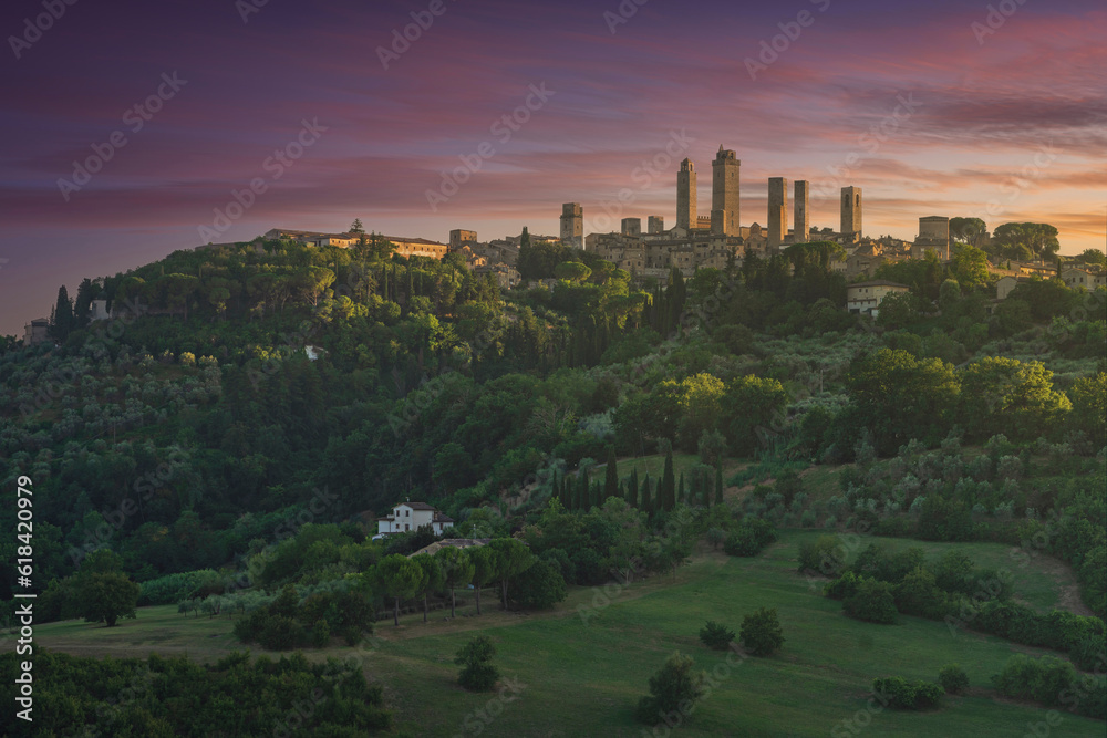 The medieval towers of the village of San Gimignano at sunset. Tuscany, Italy
